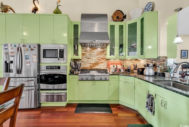 kitchen featuring stainless steel appliances, dark wood-type flooring, a sink, wall chimney range hood, and a warming drawer