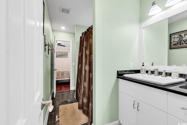 ensuite bathroom with ensuite bathroom, vanity, visible vents, and baseboards