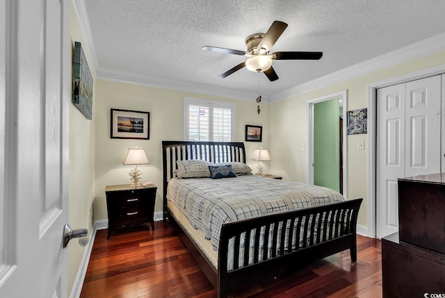 bedroom with ornamental molding, a closet, a textured ceiling, and hardwood / wood-style flooring