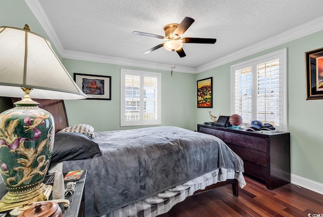 bedroom with crown molding, a textured ceiling, baseboards, and wood finished floors