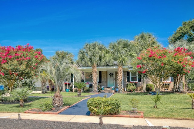 view of front facade featuring a front yard and brick siding