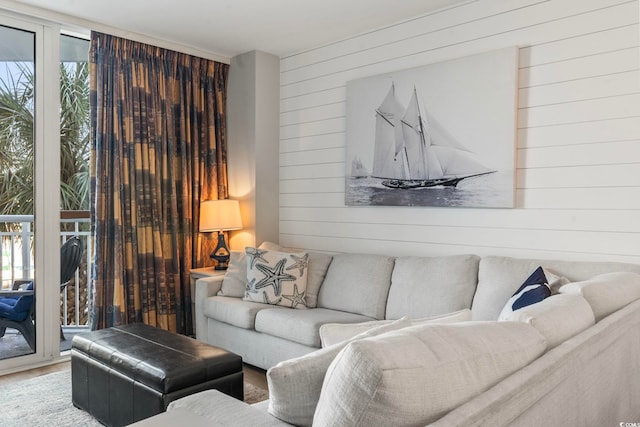 living room with wooden walls and wood finished floors