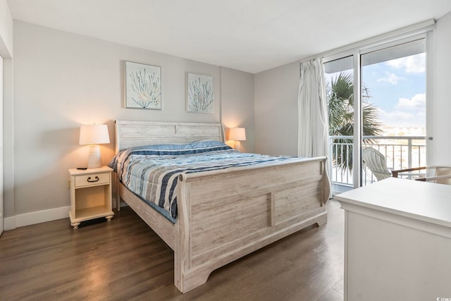 bedroom featuring expansive windows, access to outside, dark wood-type flooring, and baseboards