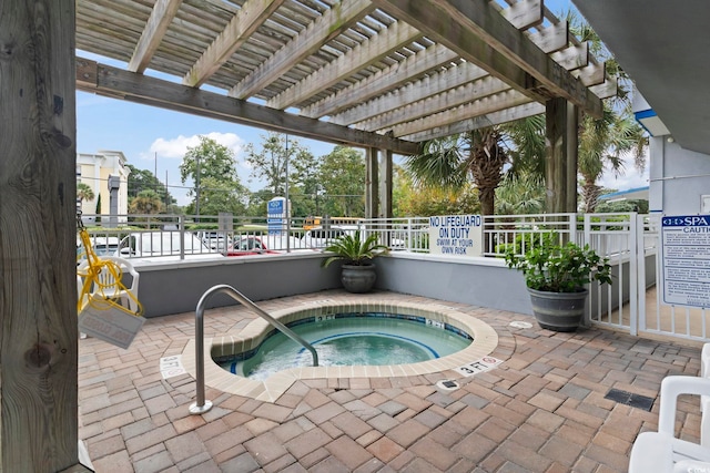 view of swimming pool with a community hot tub, a patio area, and a pergola