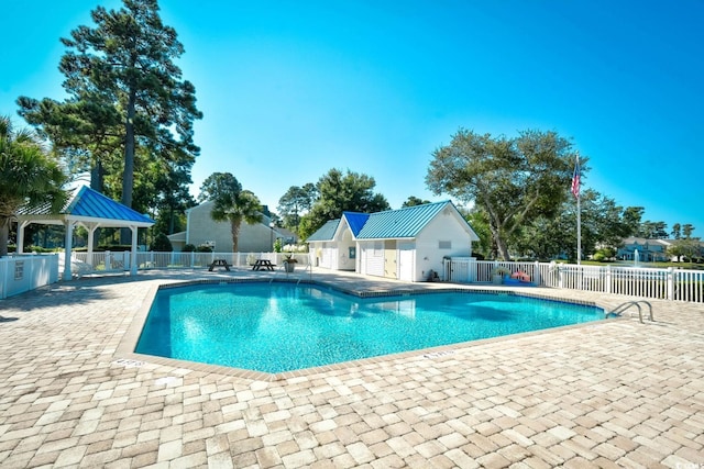 pool with a patio, a gazebo, and fence