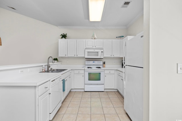 kitchen featuring light tile patterned floors, a peninsula, white appliances, a sink, and visible vents