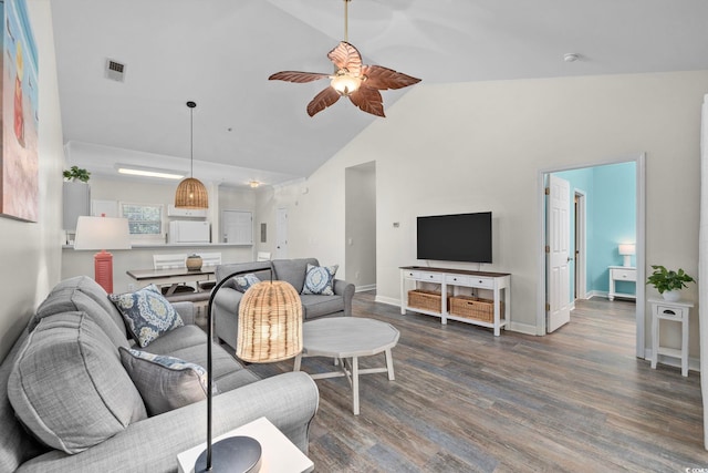 living area with baseboards, visible vents, a ceiling fan, wood finished floors, and high vaulted ceiling