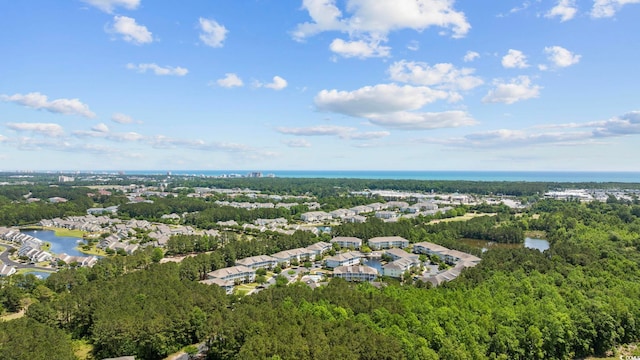 aerial view with a water view and a forest view