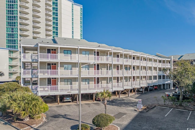 view of building exterior with uncovered parking