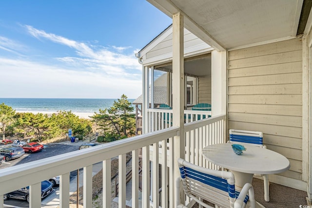 balcony with a water view and a beach view