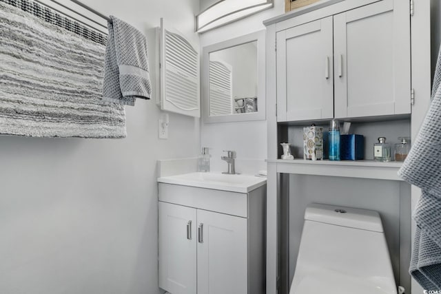 bathroom featuring vanity and toilet