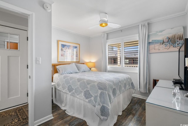 bedroom with ornamental molding, dark wood-style flooring, and a ceiling fan