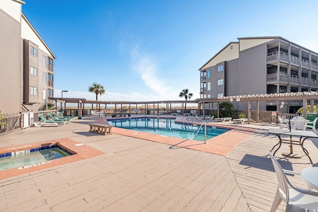 community pool with a hot tub