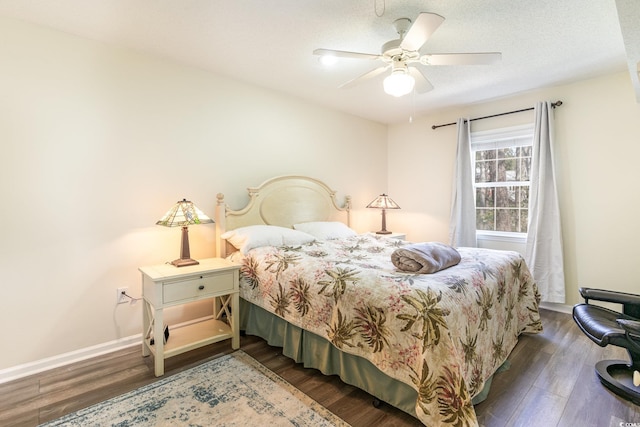 bedroom featuring a textured ceiling, wood finished floors, a ceiling fan, and baseboards