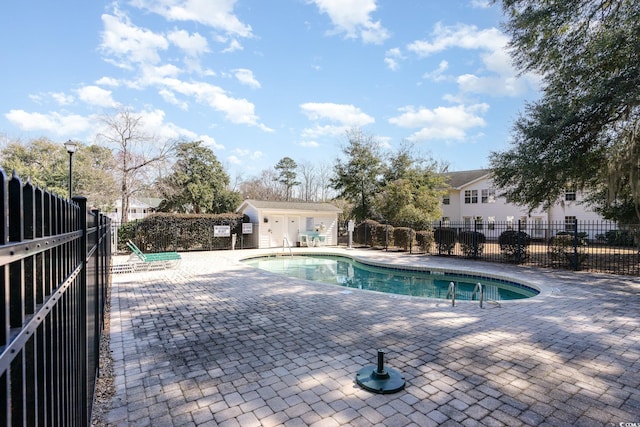 pool featuring fence and a patio