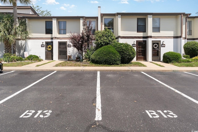 view of property featuring uncovered parking