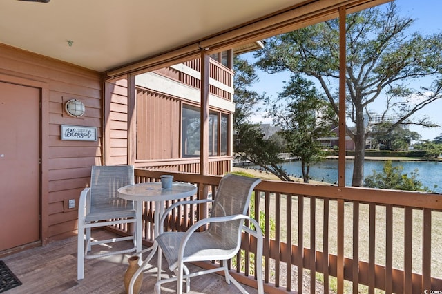 wooden deck featuring a water view