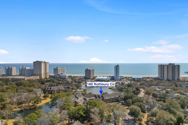 birds eye view of property featuring a water view and a view of city