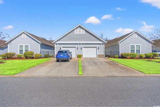 view of front of property with concrete driveway and a front yard