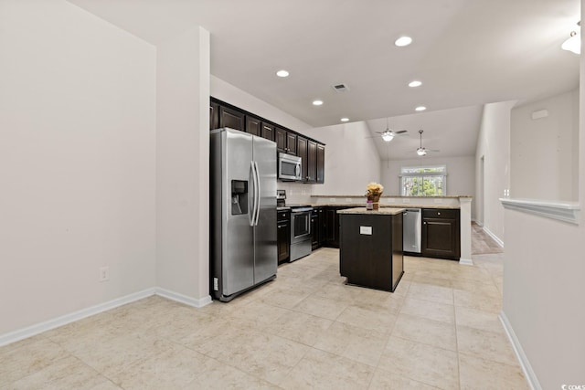 kitchen with a center island, stainless steel appliances, recessed lighting, visible vents, and baseboards