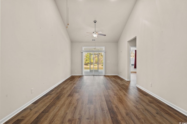 unfurnished living room featuring dark wood-style floors, high vaulted ceiling, baseboards, and a ceiling fan