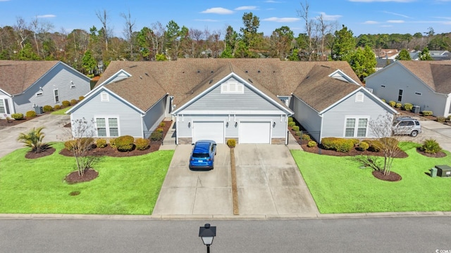 view of front of house featuring a front yard, concrete driveway, and a residential view