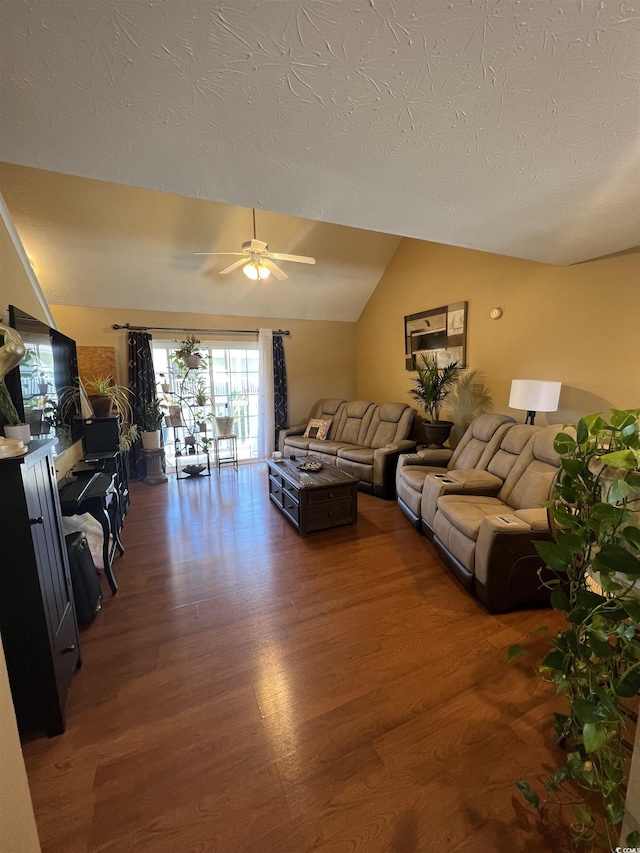 living area with lofted ceiling, ceiling fan, a textured ceiling, and wood finished floors