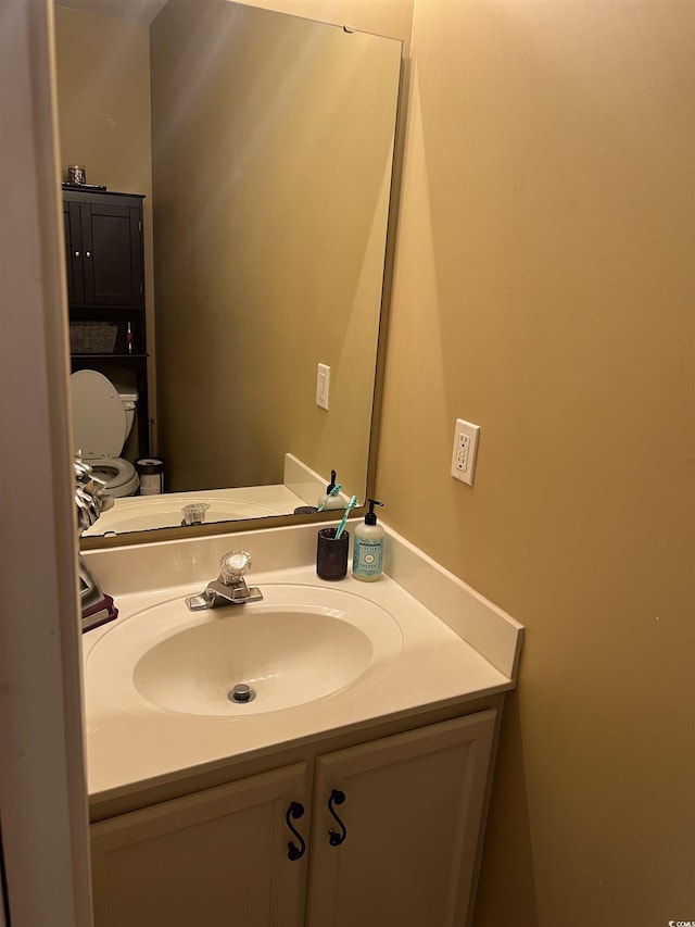 bathroom with toilet and vanity