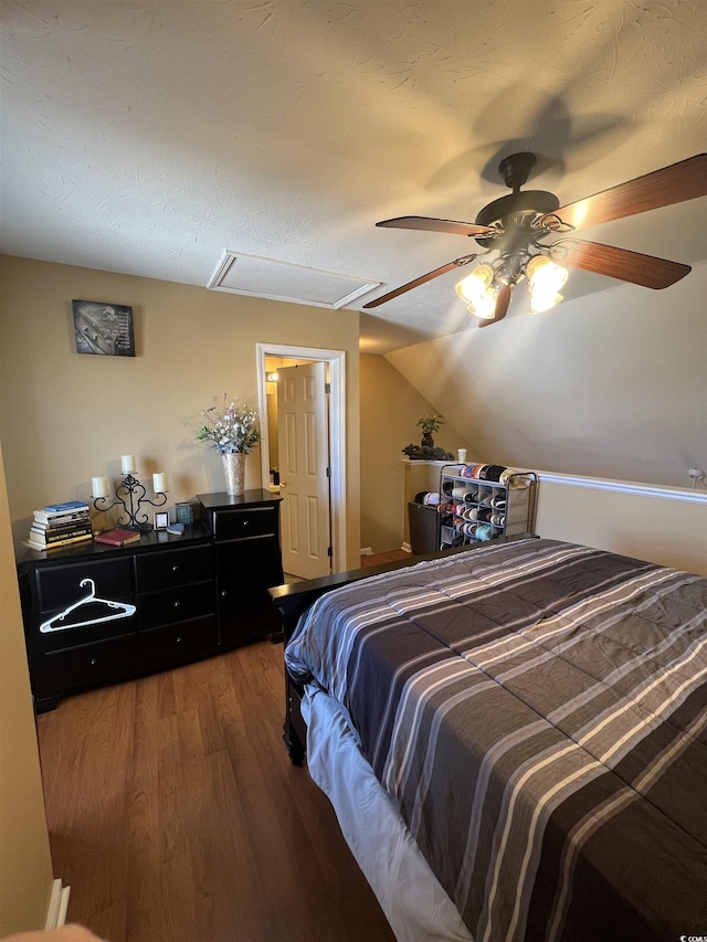 bedroom with vaulted ceiling, ceiling fan, and wood finished floors