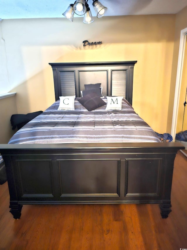 bedroom featuring dark wood finished floors