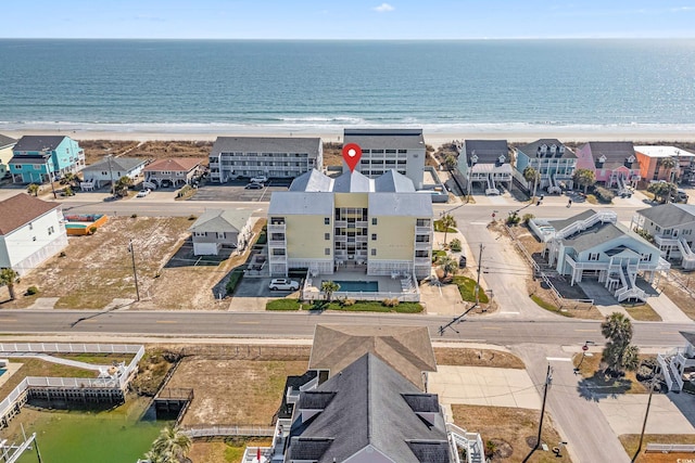 bird's eye view with a water view and a beach view