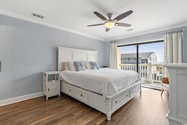 bedroom featuring ornamental molding, visible vents, and dark wood finished floors