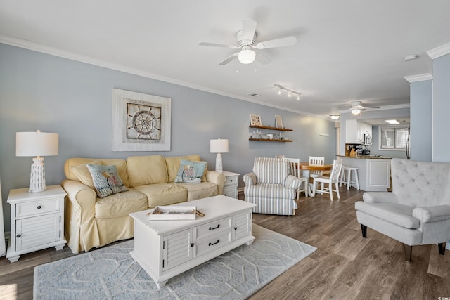 living area featuring ornamental molding, ceiling fan, and dark wood-style floors