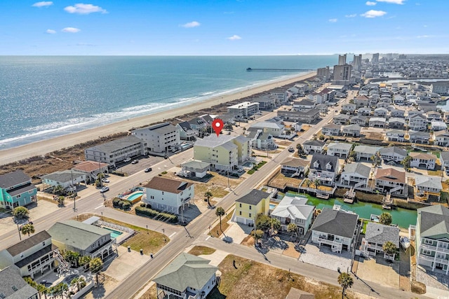 aerial view featuring a water view and a beach view