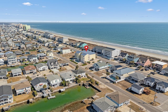 drone / aerial view featuring a water view and a beach view