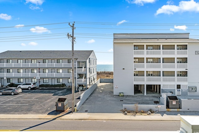 view of building exterior with uncovered parking