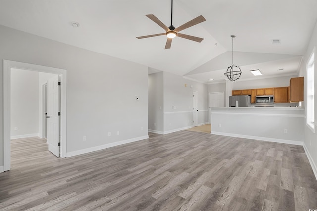 unfurnished living room featuring high vaulted ceiling, a ceiling fan, visible vents, baseboards, and light wood-type flooring