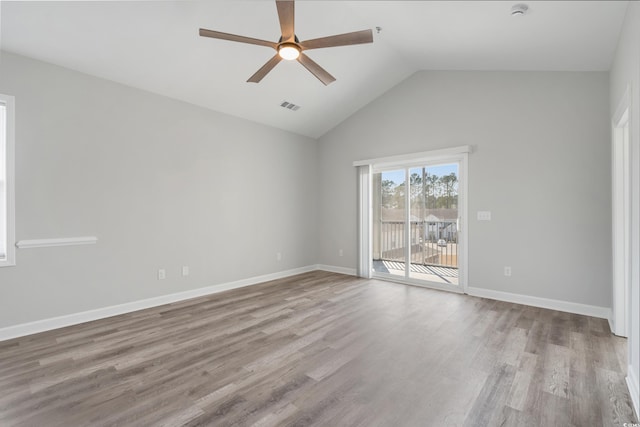 unfurnished room featuring baseboards, visible vents, and wood finished floors