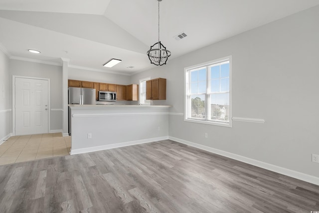 kitchen with stainless steel appliances, light countertops, visible vents, brown cabinetry, and baseboards