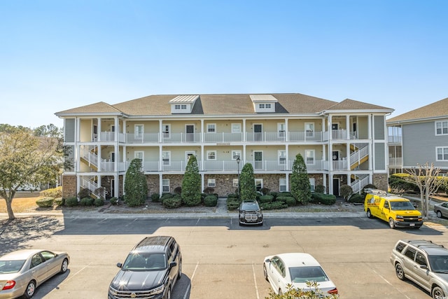 view of property featuring uncovered parking