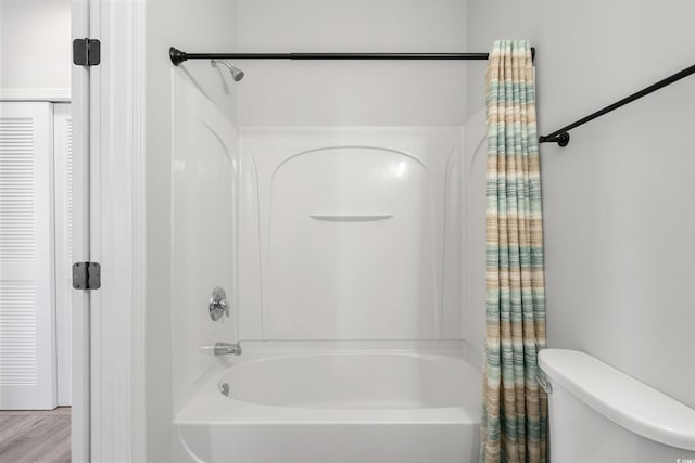 full bathroom featuring toilet and shower / bath combo with shower curtain