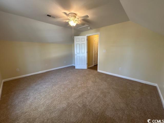 bonus room featuring ceiling fan, visible vents, baseboards, vaulted ceiling, and carpet