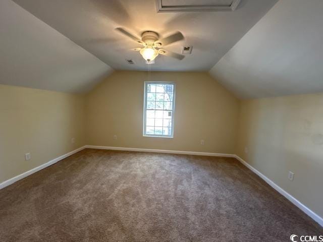 additional living space with carpet flooring, vaulted ceiling, and baseboards