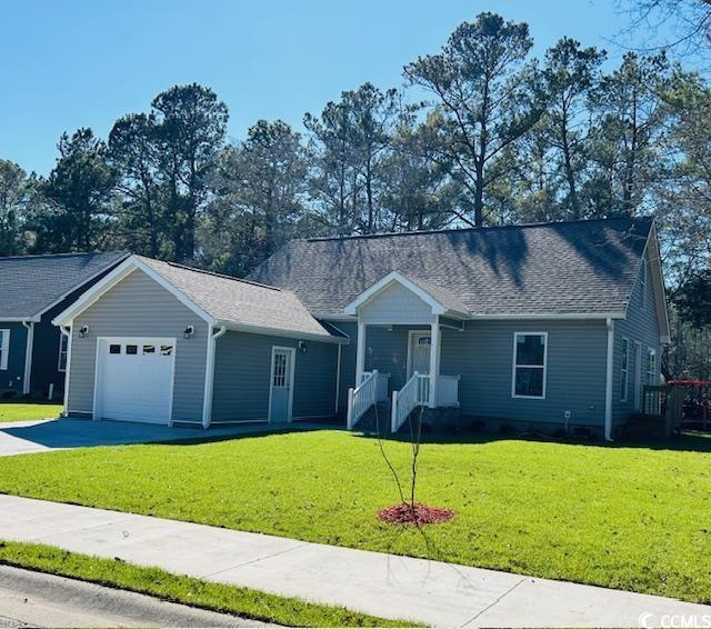 single story home with an attached garage, driveway, and a front yard