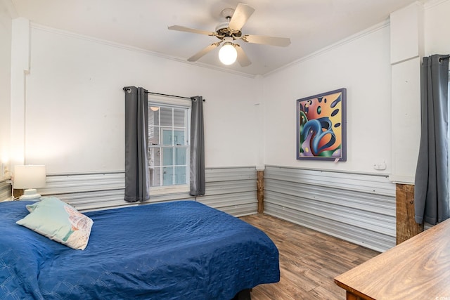 bedroom featuring crown molding, ceiling fan, and wood finished floors