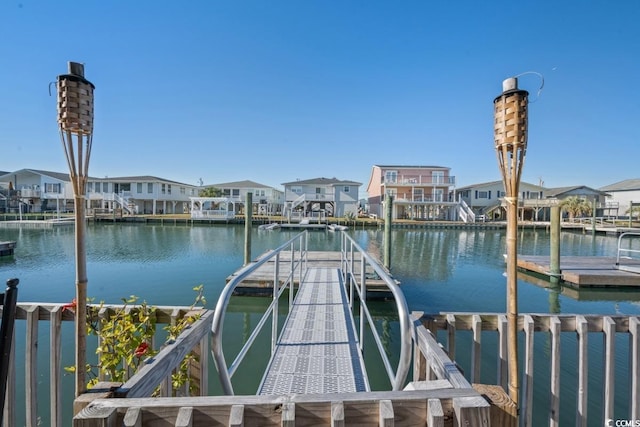 view of dock with a water view and a residential view