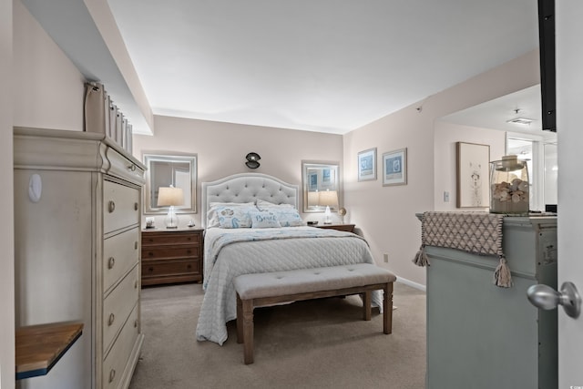 bedroom with light carpet and baseboards