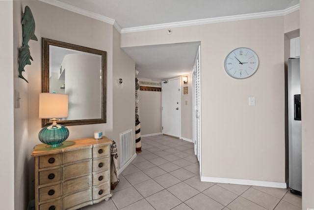 hallway with visible vents, crown molding, baseboards, and light tile patterned floors