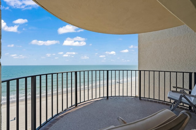 balcony with a view of the beach and a water view