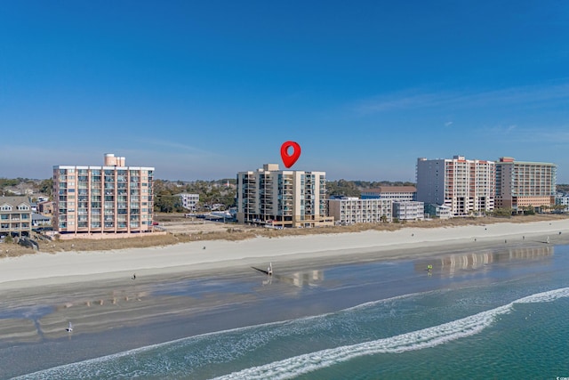 birds eye view of property with a water view, a city view, and a view of the beach